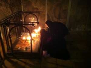 Deep inside the Church of the Holy Sepulcher, orthodox nuns light candles.